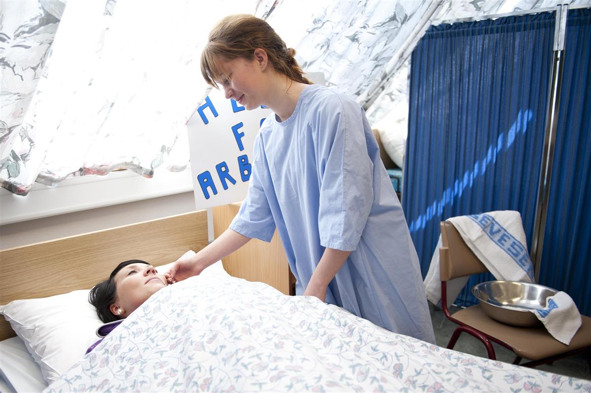 Elev ser til en pasient i en seng - Klikk for stort bilde